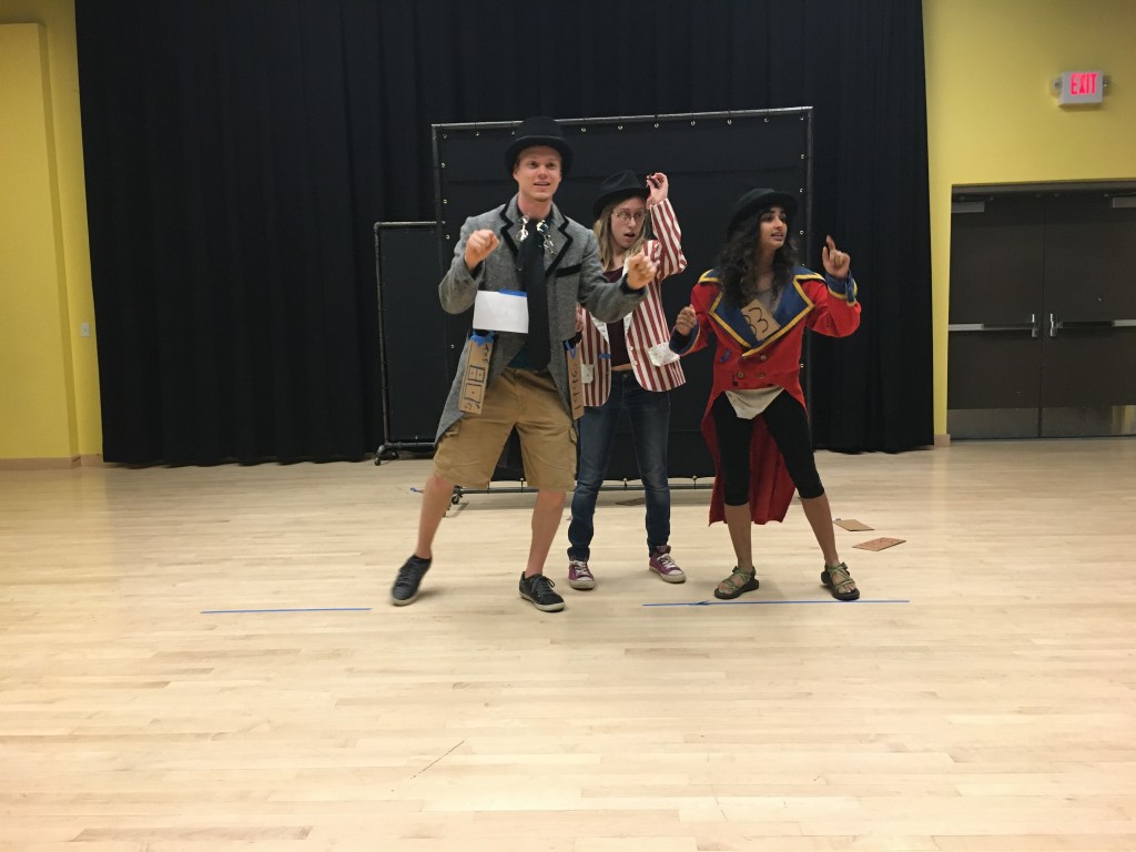 Ben Caldwell, Megan Gleason and Shireen Nori rehearse for the scene: The History of Poverty and Policy in America in under 4 minutes.