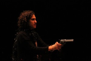 Tara McCulloch holds a gun to maintain control in one of the scenes in Cowboy Mouth.