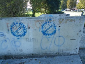 Graffiti on the bridge in Mitrovica with the country of Kosovo and the word "Serbian" stamped on it.