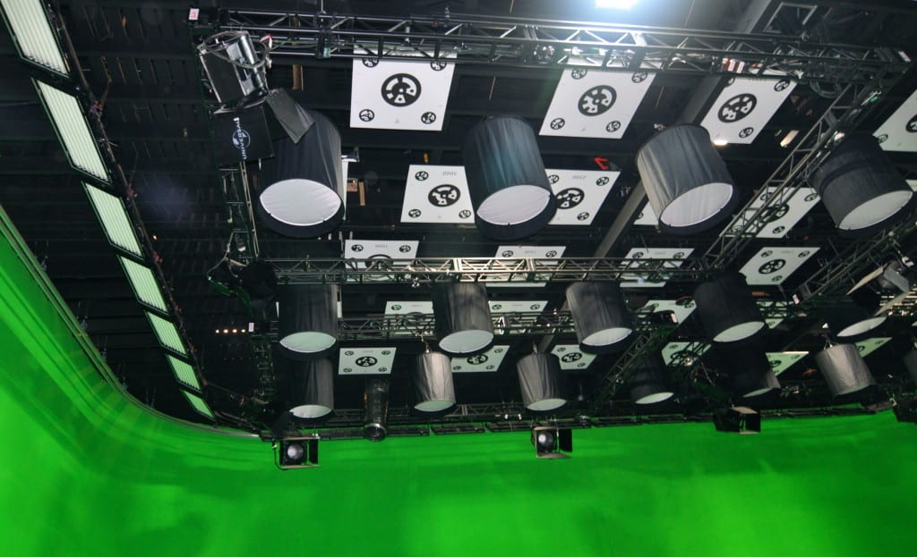 Printed black and white fiducial markers hang from the ceiling above a movie studio.